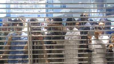 Fans peer in to the store at Marina Mall in Abu Dhabi where Manchester City players Samir Nasri, Stevan Jovetic and Matija Nastasic made an appearance on Tuesday. Mona Al-Marzooqi / The National / May 13, 2014