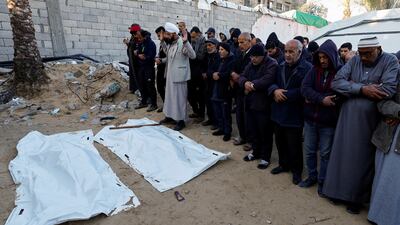 Mourners recite funeral prayers near the bodies of Palestinians killed in Israeli strikes in Khan Younis, Gaza. Reuters