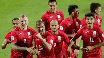 Kyrghyzstan's forward Vitalij Lux, centre with No 19 on his shirt, scored a hat-trick in his side's Asian Cup win over China. AFP