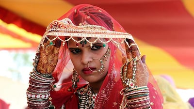 A Muslim bride takes part in a mass marriage ceremony under Mukhyamantri Kanyadan Yojna (chief minister welfare scheme) organized by the Zamia Ifzul Quran welfare Muslim Educational Society in Bhopal, India, June 9, 2014. More than 54 Muslim couples tied up the nuptial knot in the mass marriage ceremony. Some communities undertake the responsibility of arranging mass marriages for couples belonging to the financially weaker strata of the society. EPA
