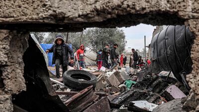 Displaced Palestinians inspect the remains of their shelters at the Rafah refugee camp following overnight Israeli strikes. AFP