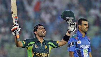 Pakistan’s Umar Akmal, left, celebrates scoring a century against Afghanistan in Fatullah on Thursday, February 27, 2014. AP