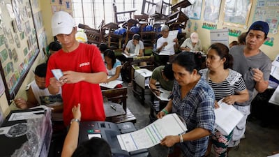 Filipinos cast their votes at an elementary school turned into a voting precinct in Quezon City, east of Manila, Philippines. . EPA