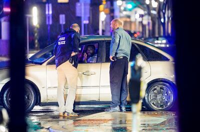 Secret Service personnel confront the man who crashed his vehicle into a Secret Service SUV. Reuters