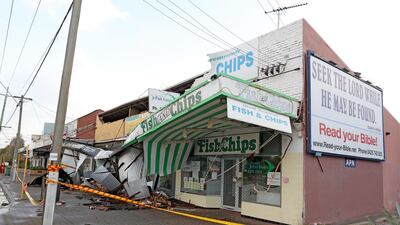 Debris covers a pavement after strong winds damaged shop fronts in Perth, Western Australia. EPA