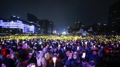 South Koreans shout slogans as they carry placards reading Park Geun-Hye Out during a rally against South Korean president Park Geun-Hye on a main street in Seoul, South Korea. EPA