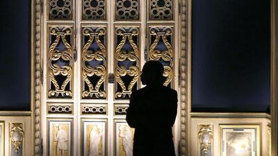 A man looks at 17th century wooden ornamental decorations which originally adorned the inside of a Parisian apartment during an exposition at the Louvre Museum in Paris. Francois Guillot/AFP