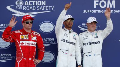 Formula One - F1 - Azerbaijan Grand Prix - Baku, Azerbaijan - June 24, 2017. Ferrari's Kimi Raikkonen of Finland, Mercedes' Lewis Hamilton of Britain and Mercedes' Valtteri Bottas of Finland wave to the media after the qualifying session. REUTERS/David Mdzinarishvili
