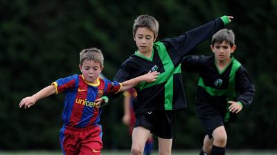 In this file photo, a Barcelona youth player duels for the ball with a Llongueras youth player on May 15, 2011 in Barcelona, Spain. Jasper Juinen / Getty Images