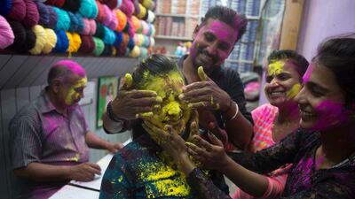 A girl's face is smeared with yellow powder in Allahabad. Rajesh Kumar Singh / AP Photo