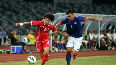 Omar Abdulrahman is challenged by a Malaysian player in a friendly which the UAE won 3-1 at Shenzhen City in China last Wednesday. Yesterday, the UAE had to play Hong Kong in a qualifier for the 2015 Asian Cup on Eid. Courtesy UAE FA