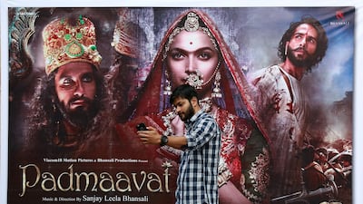 A cinemagoer takes a selfie in front of a poster of Bollywood movie 'Padmaavat' outside a movie theatre in Kochi, India, on January 25, 2018. The controversial film, which was cleared for release by India's top court despite violent protests, was banned in Malaysia on February 2, 2018. Sivaram V / Reuters