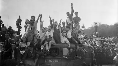 In August 1944, a cheering crowd salutes as they wait for soldiers of the Allied troops on the Place de la Concorde, during the parade to celebrate the Liberation of Paris. AFP