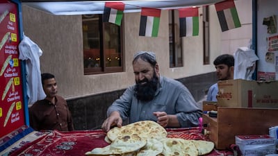 Abdulla Jan, from Afghanistan, sells freshly baked bread from his bakery.