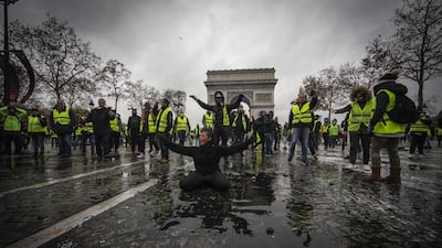 A protester is wounded by a water canon as they clash with riot police near the Arc de Triomphe in Paris. Getty Images