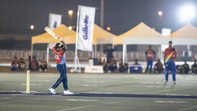 A street cricketer knocks a ball out of the park at Global Village. Antonie Robertson/The National