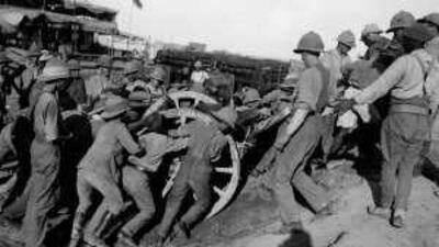 British and Indian Army soldiers shift a field gun over an embankment in 1915. During the First World War around 800,000 Indian Corps Troops fought, with Muslims comprising 40 per cent of the total.