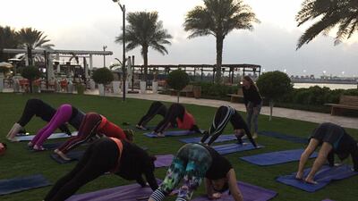 The first group to do downward dog at the new Asia de Cuba x Bodytree Yoga Supper Club, Monday nights at the Nation Riviera Beach Club. Ann Marie McQueen / The National