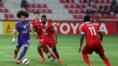 Omar Abdulrahman, left, of Al Ain in action during the Asian Champions League football match between Al Ahli and Al Ain at Rashid Stadium in Dubai. Pawan Singh / The National