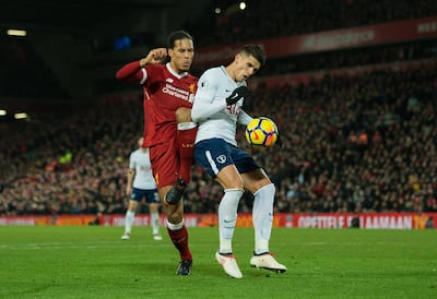 Liverpool defender Virgil van Dijk, left, tackles Tottenham substitute Erik Lamela in the area, which led to a second Tottenham penalty, dispatched by Harry Kane, for a 2-2 draw at Anfield. Peter Powell / EPA