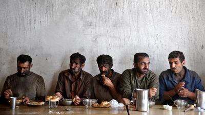 Coal miners eat lunch at a mine near the city of Zirab. The decision to privatise the coal-mining industry 10 years ago has further squeezed miners, who work often in dangerous conditions - and make just $300 a month. Ebrahim Noroozi / AP Photo