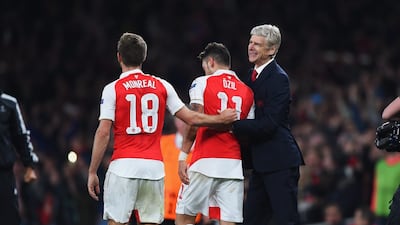 Mesut Oezil, centre, of Arsenal celebrates with teammate Nacho Monreal, left, and Arsenal manager Arsene Wenger after a second goal against Bayern Munchen at Emirates Stadium on October 20, 2015 in London, United Kingdom. (Photo by Shaun Botterill/Bongarts/Getty Images)