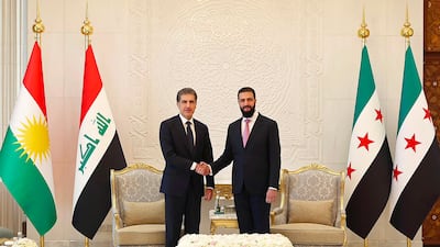 This handout photograph taken and released by the Iraq’s Kurdistan Region Presidency on August 3, 2026 shows Syria's President Ahmad al-Sharaa (R) shaking hands with the President of Iraq's Kurdish region Nechirvan Barzani before their meeting in Damascus. (Photo by Iraq’s Kurdistan Region Presidency / AFP) / RESTRICTED TO EDITORIAL USE - MANDATORY CREDIT "AFP PHOTO / Iraq’s Kurdistan Region Presidency" - HANDOUT - NO MARKETING NO ADVERTISING CAMPAIGNS - DISTRIBUTED AS A SERVICE TO CLIENTS