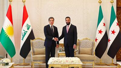 Syrian President Ahmad Al Shara shakes hands with the President of Iraq's Kurdish region Nechirvan Barzani before their meeting in Damascus. AFP
