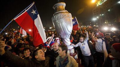 Fans of Chile celebrate after the victory. (AP Photo/Esteban Felix)