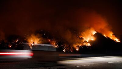 Traffic moves along the Highway 33 as a wildfires continues to burn near Oak View, California. Jae C Hong / AP Photo