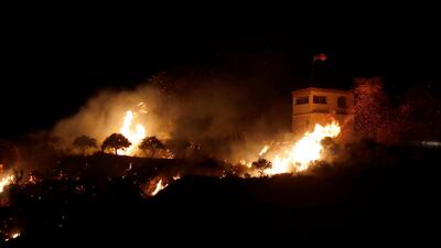 A fire seen from the Israeli side of the border on a Syrian observation post, caused by an Israeli army helicopter attack, on the Israeli-Syrian border next to the village of Majdal Shams, late. EPA
