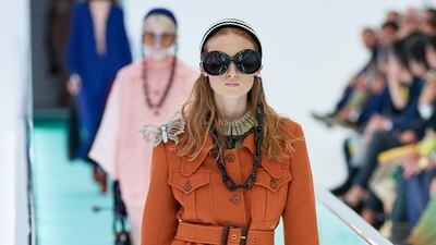 Gucci offers a safari jacket with statement necklace, a shoulder butterfly and an oversized glasses chain. Spring Summer 2020