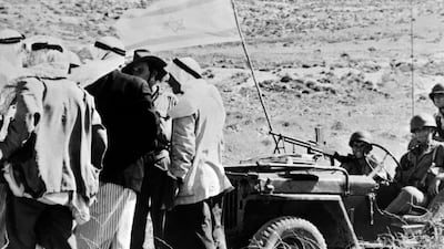 Palestinians speak with Israeli soldiers near a captured Arab village during the 1948 war. AFP