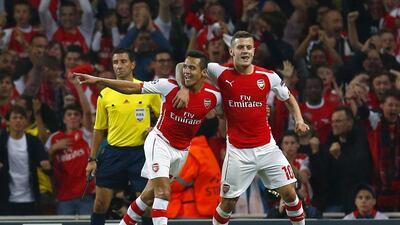 Alexis Sanchez, left, celebrates with Arsenal teammate Jack Wilshere after scoring the winner against Besiktas during their Uefa Champions League qualifier in London. Eddie Keogh / Reuters