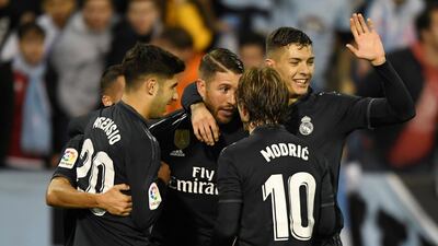 Real Madrid players celebrate with Sergio Ramos after he scores their third goal in the 4-2 win over Celta Vigo. Reuters