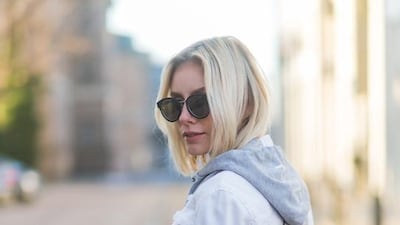 Lisa Hahnbueck wearing a white Marc Cain jacket, grey Marc Cain hoody, pink Marc Cain bag, leather pants, Marc Cain heels. Christian Vierig / Getty Images