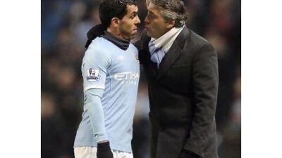 The relationship between Tevez, left, and his manager Roberto Mancini is said to be strained. Jon Super / AP Photo