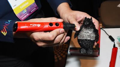 A 3D drawing pen from xyzPrinting. PLA, a corn-based plastic material, gets pushed through the tip of the pen so that it comes out melted and then cools so the user can draw 3D objects with no computer or software. IT can also be used to repair 3D-printed items. Ethan Miller / Getty Images / AFP