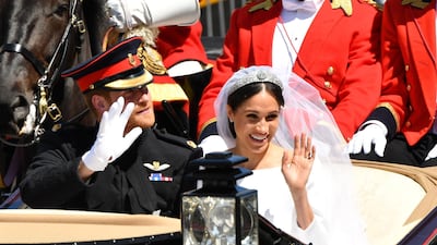WINDSOR, ENGLAND - MAY 19: Prince Harry, Duke of Sussex and Meghan, Duchess of Sussex leave Windsor Castle in the Ascot Landau carriage during a procession after getting married at St Georges Chapel on May 19, 2018 in Windsor, England. Prince Henry Charles Albert David of Wales marries Ms. Meghan Markle in a service at St George's Chapel inside the grounds of Windsor Castle. Among the guests were 2200 members of the public, the royal family and Ms. Markle's Mother Doria Ragland. (Photo by Leon Neal/Getty Images)