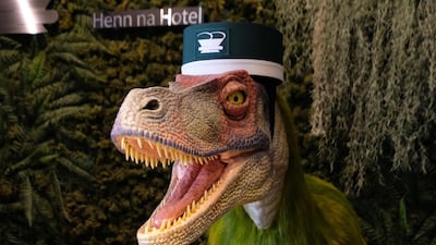 A robot dinosaur wearing a bellboy hat welcomes guests from the front desk at the Henn-na Hotel in Urayasu, suburban Tokyo. AFP