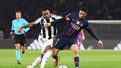 Newcastle United's Joe Willock vies for the ball with Paris Saint-Germain's Achraf Hakimi during their Uefa Champions League clash at the Parc des Princes stadium. AFP
