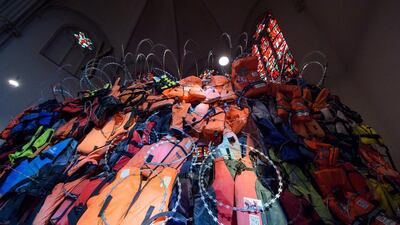 An installation ‘A wall of life jackets and their stories’ by Andrew Wakeford and Fred George is on display at Johanneskirche in Saarbruecken, Germany. The installation is made of original life jackets found on the beaches of Greece and barbed wire, along with interviews and portraits of those who have fled from the conflict in the Middle East to Europe. The exhibition runs until August 26. Oliver Dietze / EPA