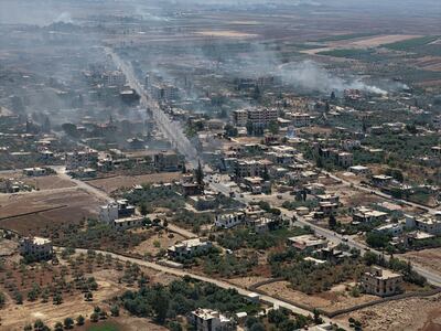 Smoke rises over Al Mazraa village during clashes between Bedouin fighters and Druze gunmen in July. Getty Images