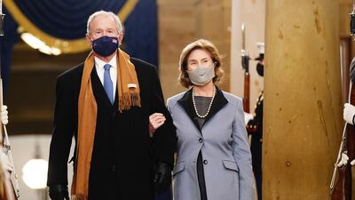 George W Bush and Laura Bush, in a jacket that toed a line between blue and lilac, arrive for the presidential inauguration. Reuters