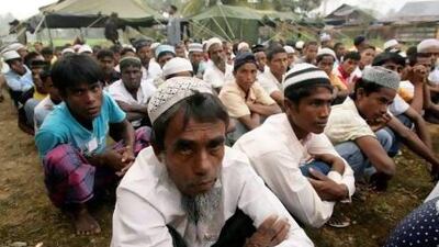 Rohingya boat people wait for their breakfast at a temporary shelter in the Idi Rayeuk district of Indonesia's Aceh province.