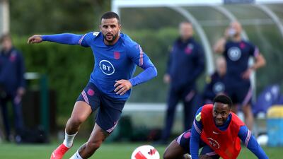 Kyle Walker runs with the ball past teammate Raheem Sterling during a training session at Tottenham Hotspur Training Centre.
