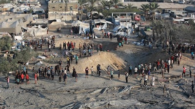 Palestinians inspect the damage after Israeli strikes on the Al Mawasi displacement camp near Khan Younis, Gaza. AFP