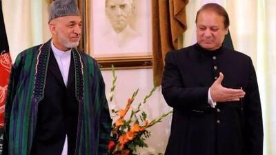 Pakistan's prime minister Nawaz Sharif (right) talks with Afghan president Hamid Karzai during their meeting in Islamabad.