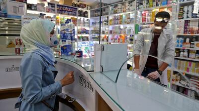 A customer wears a protective masks at a pharmacy in the Iranian capital Tehran on February 24, 2020. AFP