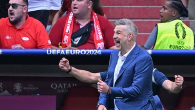 Romania's head coach Edward Iordanescu celebrates his team's third goal. AFP